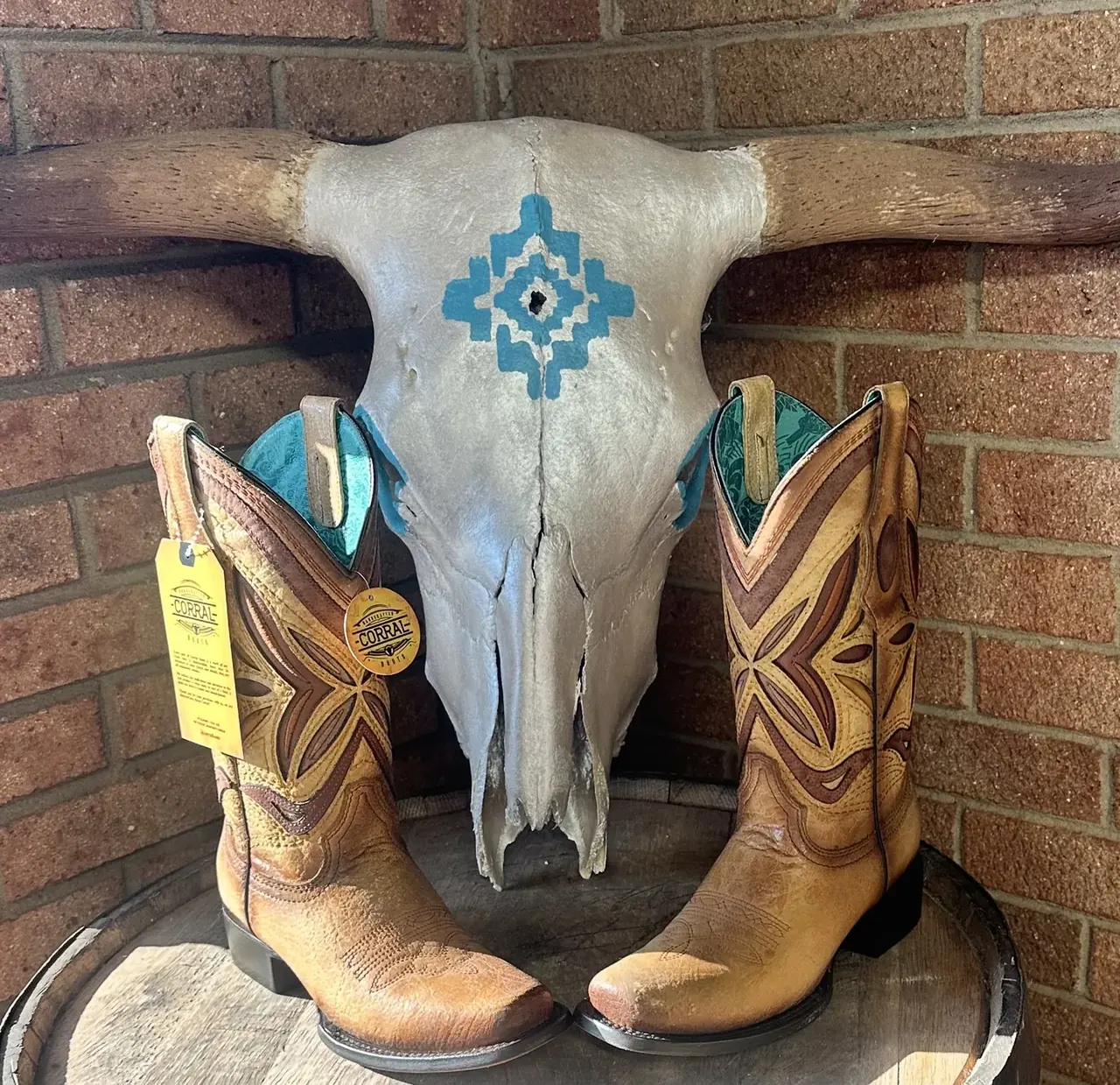 Brown cowboy boots with turquoise inlay on display at Cowboy Country Western Wear
