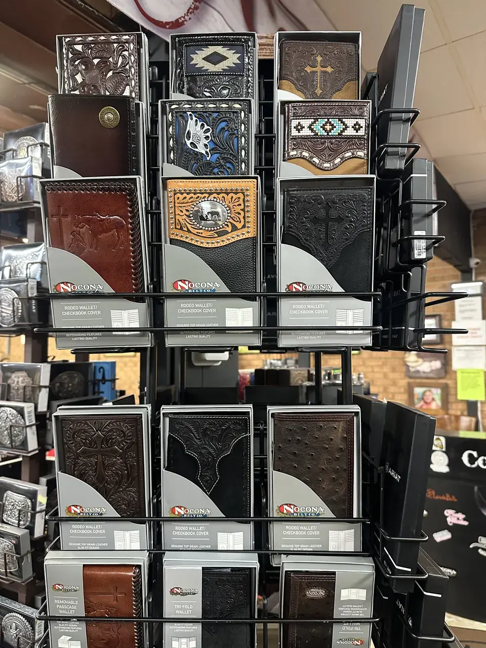 Nocona tooled-leather rodeo wallets and checkbook covers on display
